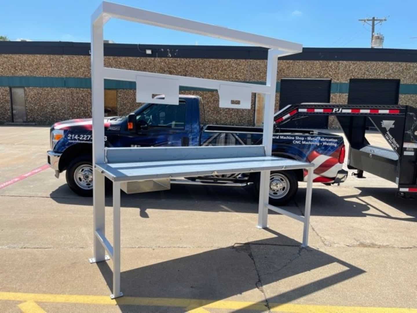 Custom fabricated stainless inspection table with overhead light bar built by Kimbrell Manufacturing Corporation