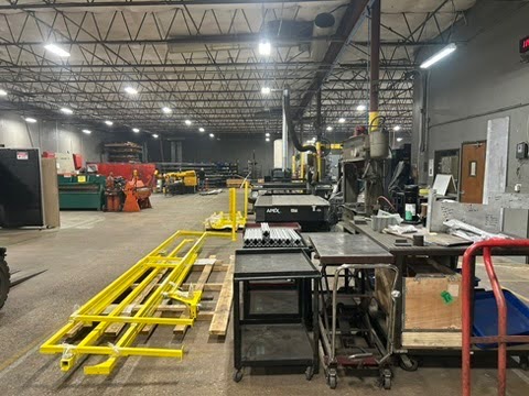 Wide view inside the Kimbrell Manufacturing Corporation shop floor in Garland, Texas, with fabrication tables and equipment