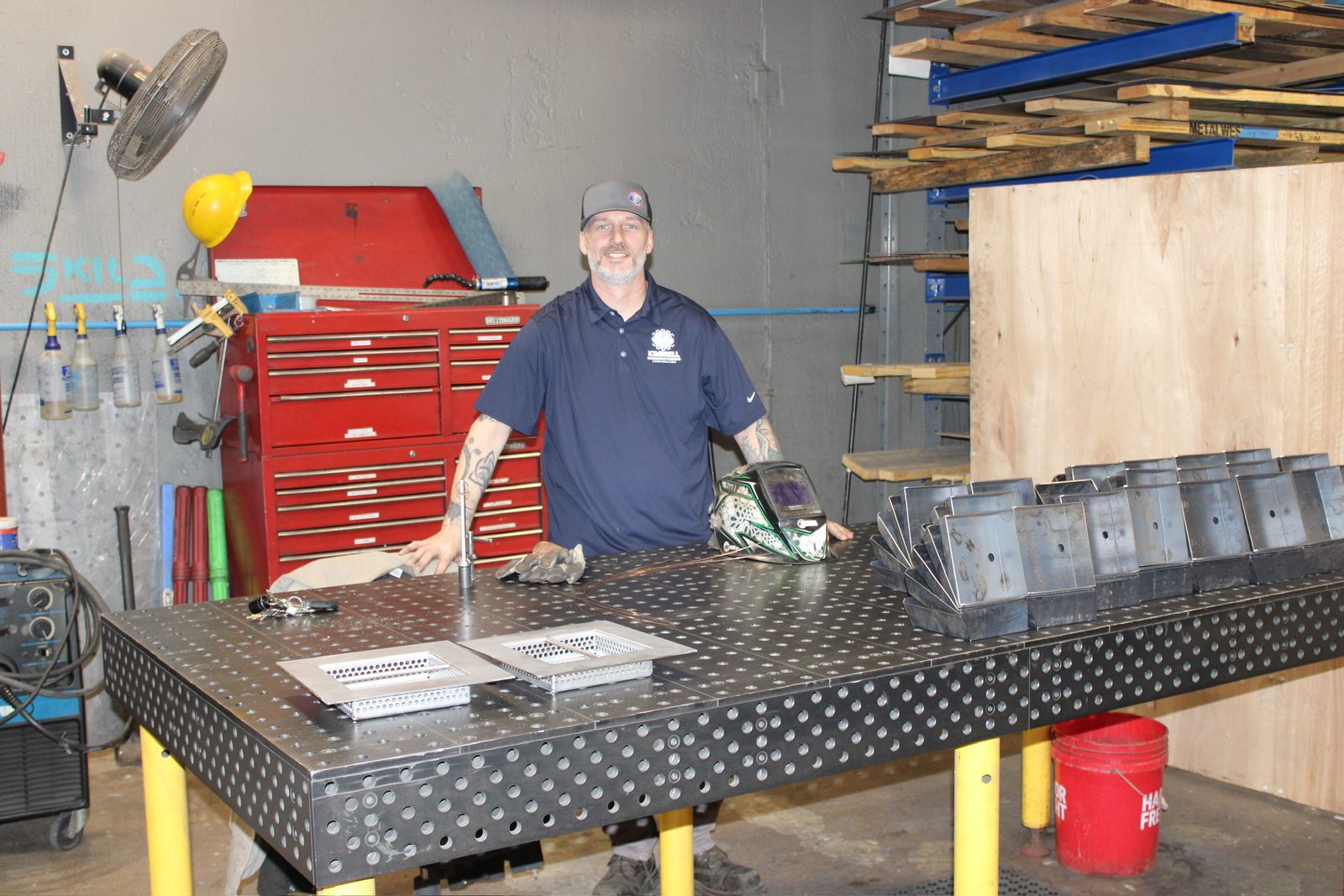 A Kimbrell team member at a fabrication table with recently made parts