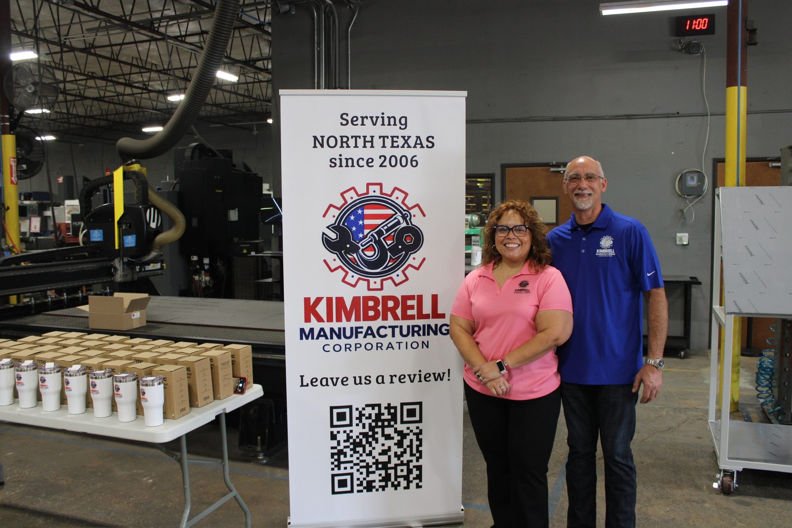 Two Kimbrell team members beside the Serving North Texas since 2006 banner