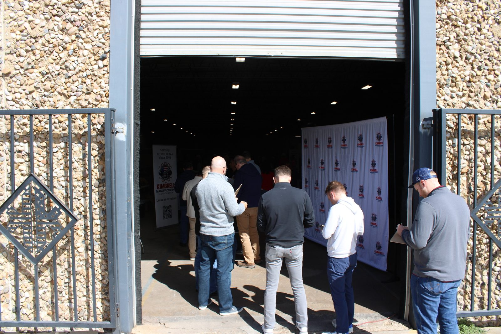 Guests arriving through the shop door past the Kimbrell photo wall