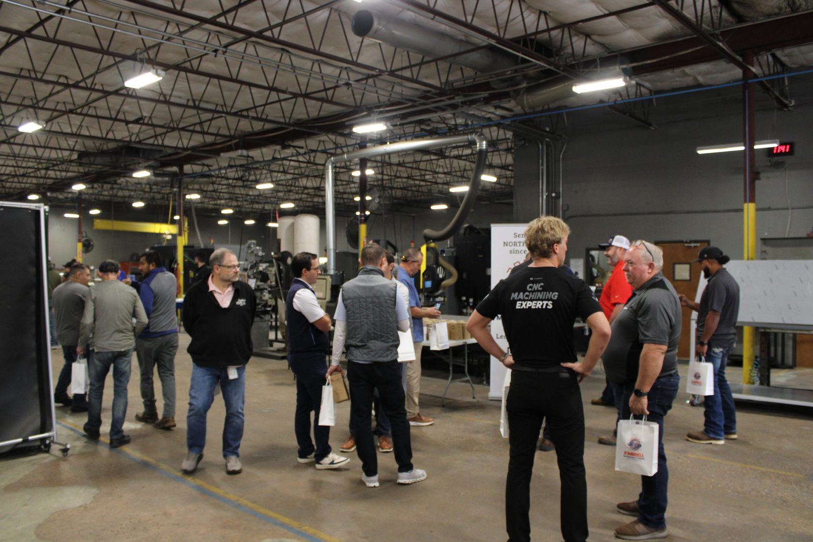 Guests touring the machining area of the shop