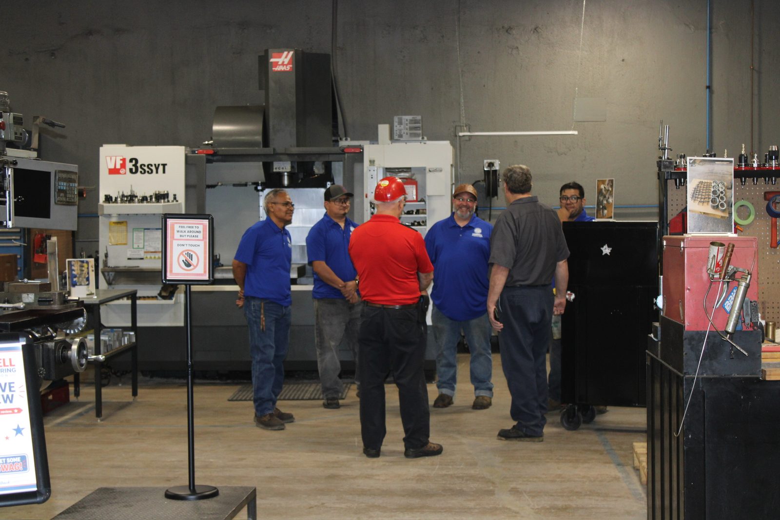 Kimbrell team members talking with a guest near the CNC machines