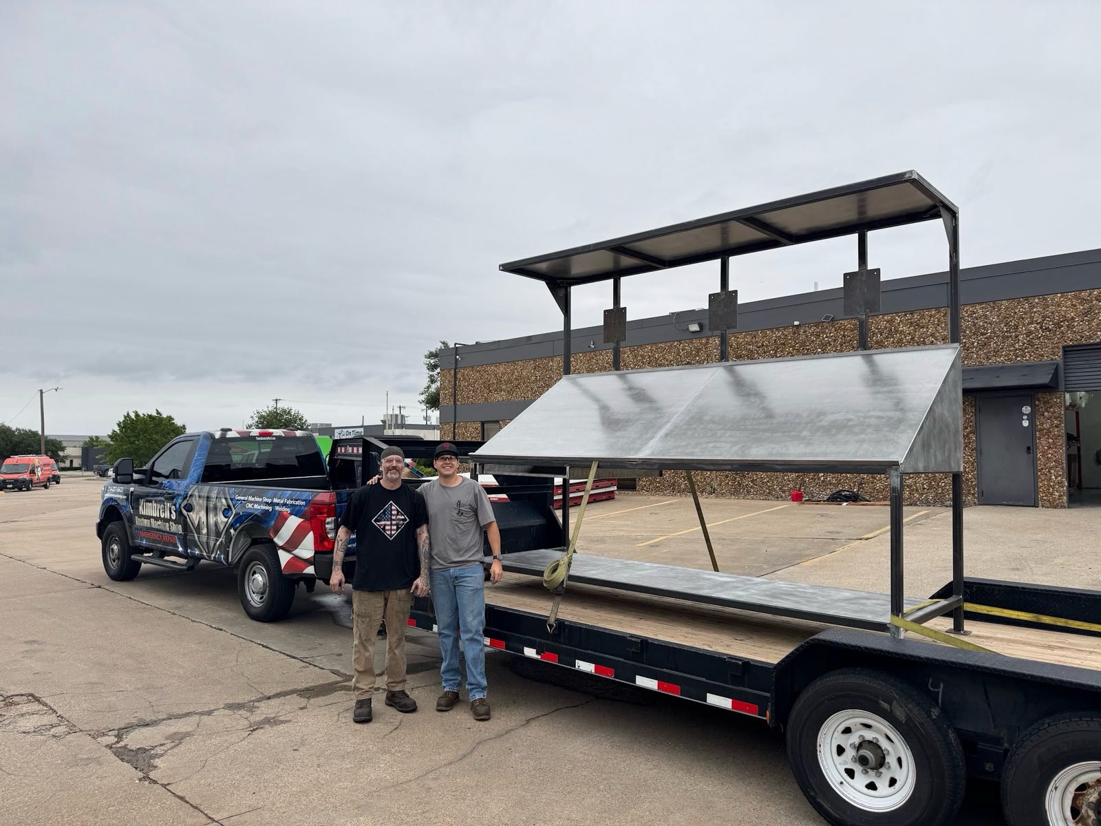 Kimbrell team members with a finished fabricated canopy assembly loaded for delivery outside the Garland shop