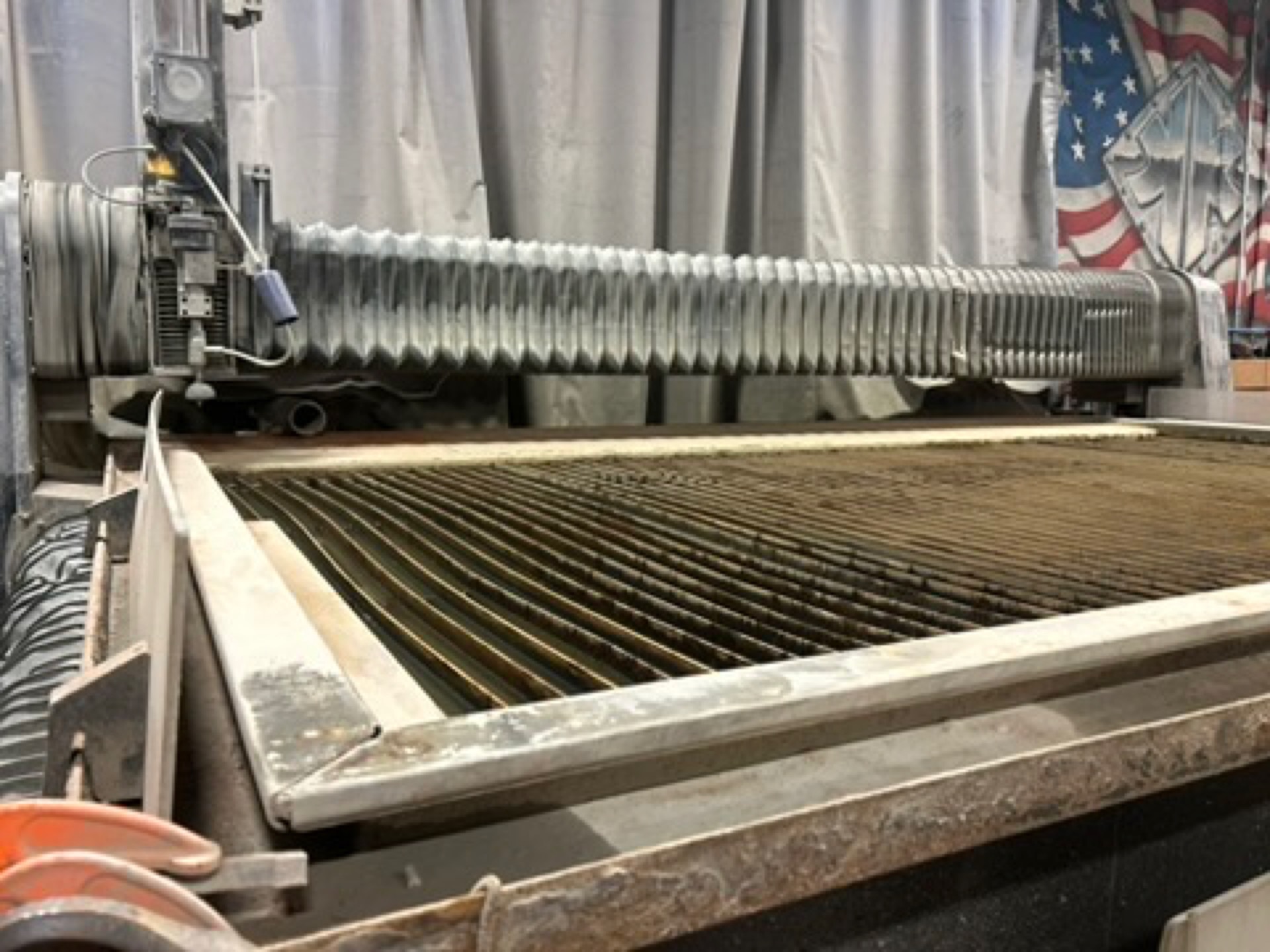 Kimbrell Manufacturing Corporation's 90,000 PSI waterjet cutting system and tank bed on the Garland, Texas shop floor